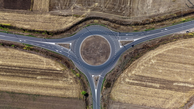 Aerial view of a roundabout surrounded by vast agricultural fields and rural roads in Bavaniste Vojvodina Serbia.