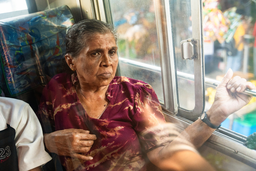 Sri Lanka 16 January 2026 View of an elderly woman sitting on a bus and looking out the window.