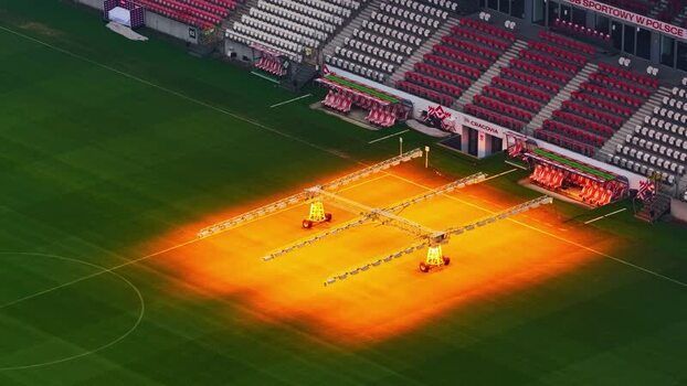 Aerial view of Cracovia stadium pitch with grow lights in Poland.
