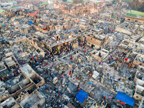 Aerial view of a landscape scarred by fire with remnants of homes amidst a sea of ash and debris Dhaka Dhaka Division Bangladesh. Aerial view of a landscape scarred by fire with remnants of homes amidst a sea of ash and debris Dhaka Dhaka Division Bangladesh.