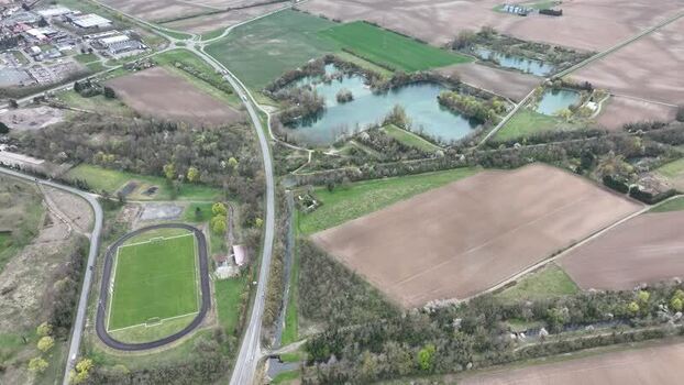 Aerial view of lake fields and soccer field France.