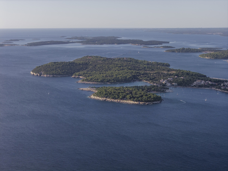 Aerial view of the lush green islands and coastline of Pjescana Uvala surrounded by the deep blue Adriatic Sea in Pula Istarska zupanija Croatia.