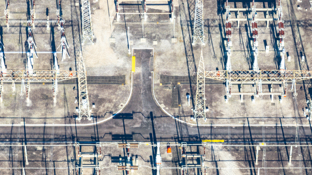 Aerial view of the electrical substation at Nuclear Power Plant Angra 2 with power lines metal towers and industrial equipment on gravel ground in Angra dos Reis Rio de Janeiro Brazil.