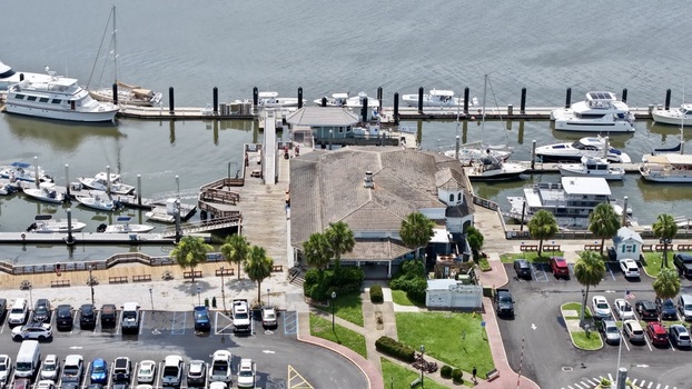Aerial view of boats docked in the marina cars in the parking lot and a building on the pier Fernandina Beach Florida United States. Aerial view of boats docked in the marina cars in the parking lot and a building on the pier Fernandina Beach Florida United States.