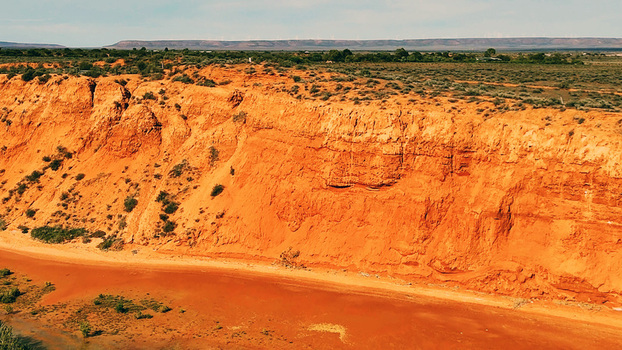 Aerial view of Matthew Flinders Red Cliff Lookout featuring the striking red sandstone cliffs sparse vegetation and arid landscape in Port Augusta West South Australia Australia. Aerial view of Matthew Flinders Red Cliff Lookout featuring the striking red sandstone cliffs sparse vegetation and arid landscape in Port Augusta West South Australia Australia.