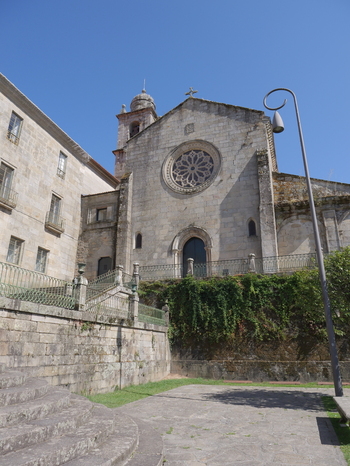 View of Convento e Igrexa de San Francisco with its stone facade rose window and surrounding historic walls under a clear blue sky in Pontevedra Pontevedra Spain. View of Convento e Igrexa de San Francisco with its stone facade rose window and surrounding historic walls under a clear blue sky in Pontevedra Pontevedra Spain.