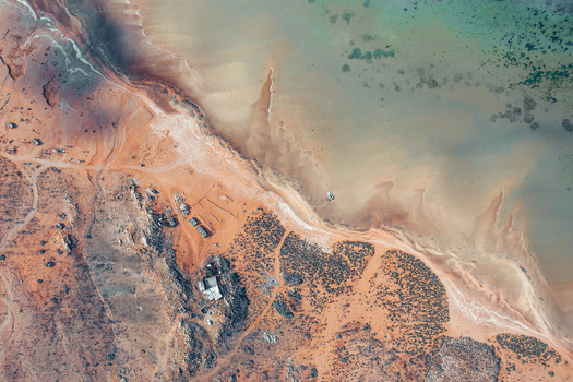 Aerial view of Detwah Lagoon featuring turquoise waters sandy shores and arid landscape with sparse vegetation in Qalansiyah wa Abd Al Kuri Socotra Yemen. Aerial view of Detwah Lagoon featuring turquoise waters sandy shores and arid landscape with sparse vegetation in Qalansiyah wa Abd Al Kuri Socotra Yemen.