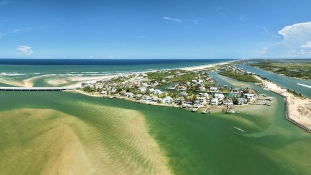 Aerial view of Matanzas Inlet showing the bridge coastal homes sandbars and the Atlantic Ocean in St. Johns County Florida United States. Aerial view of Matanzas Inlet showing the bridge coastal homes sandbars and the Atlantic Ocean in St. Johns County Florida United States.