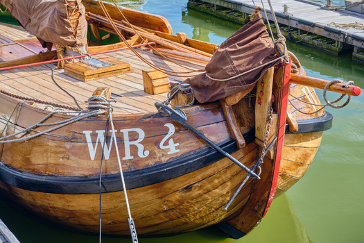 Den Oever Netherlands 18 May 2026 View of the wooden hull and deck of a historic Wieringeraak sailing vessel moored in the fishing harbor under bright daylight. Den Oever Netherlands 18 May 2026 View of the wooden hull and deck of a historic Wieringeraak sailing vessel moored in the fishing harbor under bright daylight.