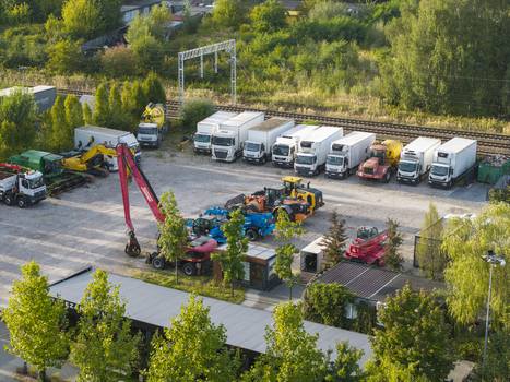 Krakow Malopolska Poland 16 September 2026 Aerial view of the CIEZAROWKI.PL logistics yard with parked semi trucks excavators and heavy machinery in a gravel lot.