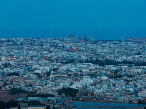 Aerial view of the historic fortified city of Mdina with its ancient stone buildings narrow streets and surrounding landscape under a twilight sky in Mdina Western Region Malta. Aerial view of the historic fortified city of Mdina with its ancient stone buildings narrow streets and surrounding landscape under a twilight sky in Mdina Western Region Malta.