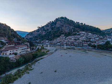 Aerial view of the historic city of Berat with its traditional stone houses the Osum River and the castle on the hill in Berat Berat County Albania.