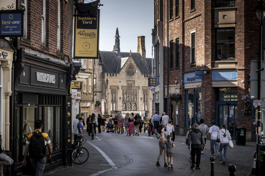 Durham United Kingdom 13 July 2026 View of a bustling street in Durham with historic brick architecture shops and pedestrians walking along the cobblestone path. Durham United Kingdom 13 July 2026 View of a bustling street in Durham with historic brick architecture shops and pedestrians walking along the cobblestone path.