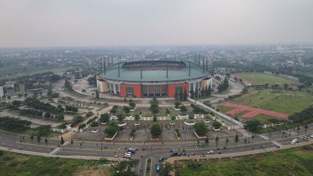 Aerial view of Pakansari Stadium surrounded by parking areas green spaces and urban infrastructure in Kecamatan Cibinong Jawa Barat Indonesia. Aerial view of Pakansari Stadium surrounded by parking areas green spaces and urban infrastructure in Kecamatan Cibinong Jawa Barat Indonesia.