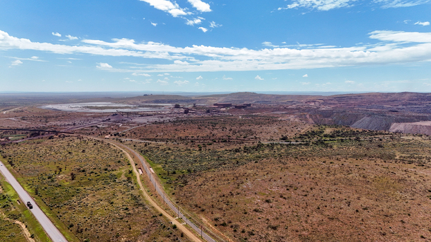 Aerial view of a sprawling industrial mining complex amidst a vast arid landscape with contrasting dry earth and sparse vegetation Rustenburg North West South Africa. Aerial view of a sprawling industrial mining complex amidst a vast arid landscape with contrasting dry earth and sparse vegetation Rustenburg North West South Africa.