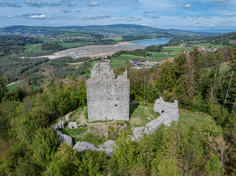Aerial view of Burg Montsalvens a historic stone castle ruin surrounded by lush green forests and rolling hills in the Fribourg region overlooking the landscape near Broc Fribourg Switzerland. Aerial view of Burg Montsalvens a historic stone castle ruin surrounded by lush green forests and rolling hills in the Fribourg region overlooking the landscape near Broc Fribourg Switzerland.