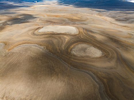 Aerial view of the unique geological patterns and sandy textures of the undulating Icelandic highlands in Iceland. Aerial view of the unique geological patterns and sandy textures of the undulating Icelandic highlands in Iceland.