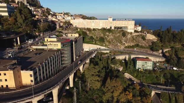 Aerial view of Excelsior Palace and coastal road in Taormina Italy.