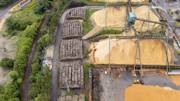 Aerial view of the Biofabrica de Ence with large piles of wood chips and stacked timber logs in Pontevedra Pontevedra Spain. Aerial view of the Biofabrica de Ence with large piles of wood chips and stacked timber logs in Pontevedra Pontevedra Spain.