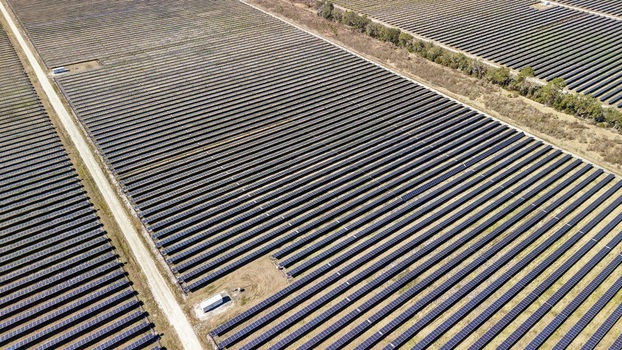 Aerial view of endless rows of solar panels gleam under the sun contrasting with the earthy tones of the fields Elkton Florida United States. Aerial view of endless rows of solar panels gleam under the sun contrasting with the earthy tones of the fields Elkton Florida United States.