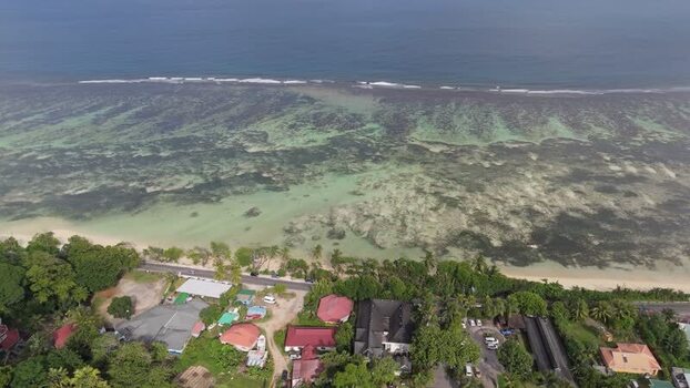 Aerial view of Mahe coastline with turquoise waters Seychelles.