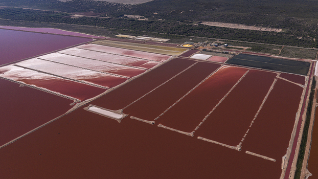 Aerial view of vibrant pink salt production ponds with geometric patterns and embankments in Kalbarri Western Australia Australia. Aerial view of vibrant pink salt production ponds with geometric patterns and embankments in Kalbarri Western Australia Australia.