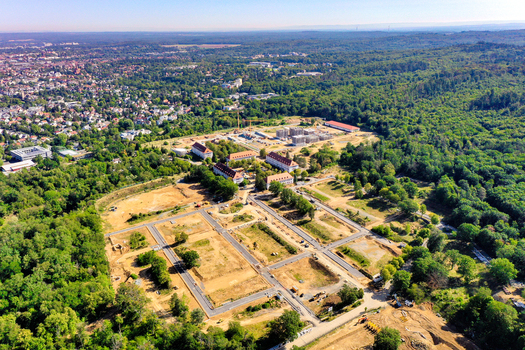Aerial view of the Bessungen district construction site surrounded by lush green forest and residential buildings in Darmstadt Hessen Germany.