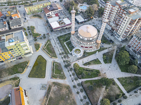 Aerial view of Fier Mosque surrounded by urban plazas green spaces and city buildings in Fier Fier County Albania. Aerial view of Fier Mosque surrounded by urban plazas green spaces and city buildings in Fier Fier County Albania.