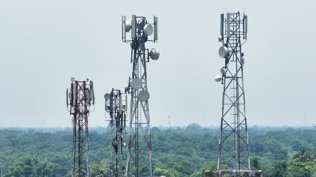 Aerial view of telecommunication towers over a green forest. Aerial view of telecommunication towers over a green forest.