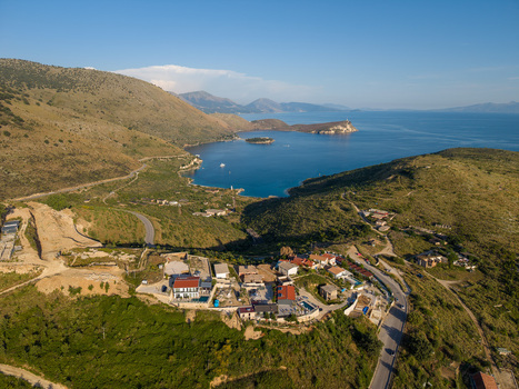 Aerial view of Porto Palermo Castle on a peninsula overlooking the turquoise bay and green hills in Porto Palermo Qarku i Vlores Albania. Aerial view of Porto Palermo Castle on a peninsula overlooking the turquoise bay and green hills in Porto Palermo Qarku i Vlores Albania.