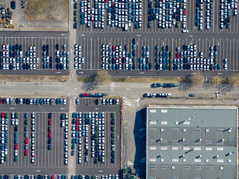 Aerial view of countless cars neatly aligned in rows creating a vibrant tapestry of colors and geometric patterns across the landscape Sausheim Grand Est France.