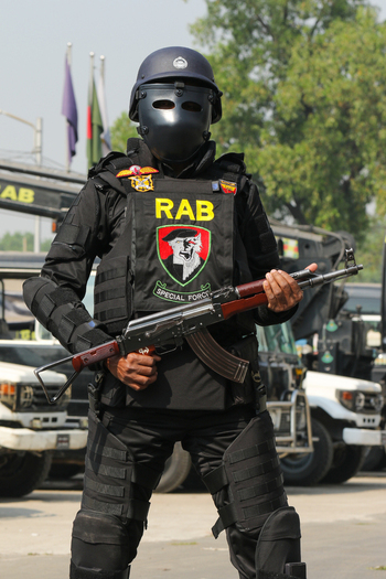 Dhaka Bangladesh 08 January 2017 View of a member of the Rapid Action Battalion RAB in full tactical gear and face mask holding an assault rifle at the RAB Headquarters. Dhaka Bangladesh 08 January 2017 View of a member of the Rapid Action Battalion RAB in full tactical gear and face mask holding an assault rifle at the RAB Headquarters.