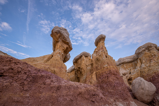View of Paint Mines Interpretive Park featuring colorful hoodoos and unique rock formations under a blue sky Calhan Colorado United States.