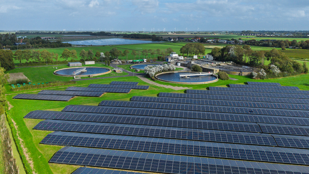 Aerial view of the wastewater treatment plant at Schagerweg 2 featuring circular sedimentation tanks and a large solar panel array in Schagerbrug Noord Holland Netherlands. Aerial view of the wastewater treatment plant at Schagerweg 2 featuring circular sedimentation tanks and a large solar panel array in Schagerbrug Noord Holland Netherlands.