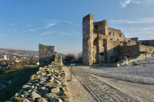 View of the ancient stone ruins of Devin Castle with defensive walls and a paved path under a clear blue sky in Bratislava IV Bratislava Region Slovakia. View of the ancient stone ruins of Devin Castle with defensive walls and a paved path under a clear blue sky in Bratislava IV Bratislava Region Slovakia.
