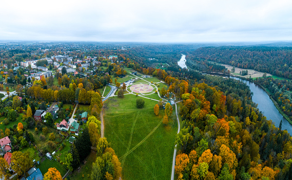 Aerial view of Sigulda in autumn with the Gauja River winding through the forest a park with a circular design and a Ferris wheel in Sigulda Sigulda Municipality Latvia. Aerial view of Sigulda in autumn with the Gauja River winding through the forest a park with a circular design and a Ferris wheel in Sigulda Sigulda Municipality Latvia.