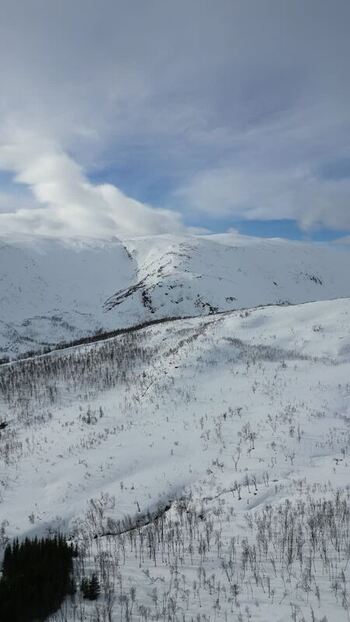 Aerial view of snow covered mountains on Kvaloya island Norway.