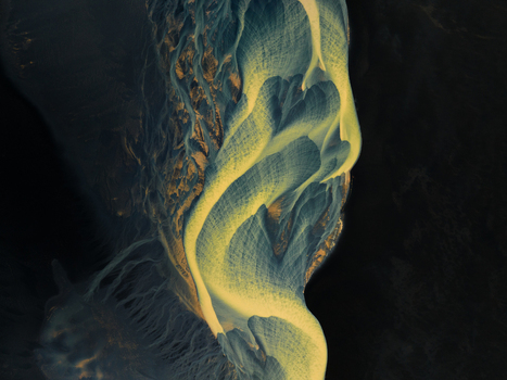 Aerial view of winding glacial rivers carve through the stark landscape a dance of pale blues and ochre against the dark earth Iceland. Aerial view of winding glacial rivers carve through the stark landscape a dance of pale blues and ochre against the dark earth Iceland.