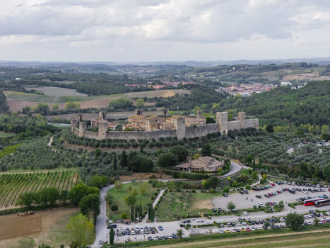 Aerial view of the historic walled town of Monteriggioni surrounded by olive groves and rolling hills in the Tuscan countryside Monteriggioni Tuscany Italy.