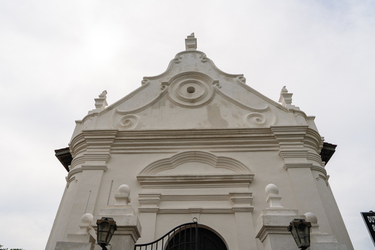 View of the ornate white facade and curved gable of the historic Dutch Reformed Church under an overcast sky in Galle Southern Province Sri Lanka.