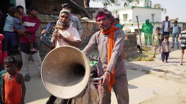 View of musicians with a large horn in a village Nepal.