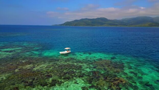Aerial view of a boat over a coral reef Honduras. Aerial view of a boat over a coral reef Honduras.