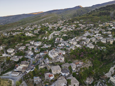 Aerial view of the historic stone houses with traditional slate roofs in the old town of Gjirokaster Gjirokaster County Albania. Aerial view of the historic stone houses with traditional slate roofs in the old town of Gjirokaster Gjirokaster County Albania.