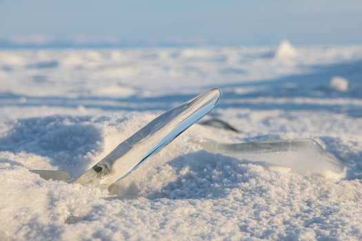 View of a sharp ice shard protruding from the frozen snow covered surface of Lake Baikal Severobaykalsk Buryatia Russia. View of a sharp ice shard protruding from the frozen snow covered surface of Lake Baikal Severobaykalsk Buryatia Russia.