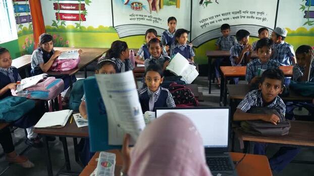 View of students in a classroom with a teacher Bangladesh.