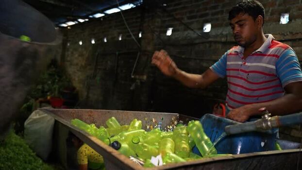 View of a worker recycling plastic bottles in Bogura Bangladesh. View of a worker recycling plastic bottles in Bogura Bangladesh.