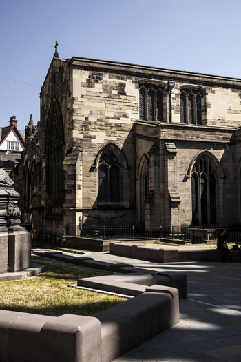 View of the historic St. Nicholas Cathedral with its stone masonry gothic windows and surrounding paved square in Newcastle upon Tyne England United Kingdom. View of the historic St. Nicholas Cathedral with its stone masonry gothic windows and surrounding paved square in Newcastle upon Tyne England United Kingdom.