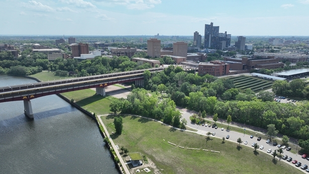 Aerial view of a bridge crossing a river with buildings and greenery in the background Minneapolis Minnesota United States.