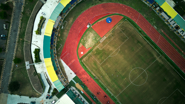 Aerial view of MKO Stadium Training Pitch with its red running track and green grass field surrounded by stadium seating in Abeokuta Ogun State Nigeria. Aerial view of MKO Stadium Training Pitch with its red running track and green grass field surrounded by stadium seating in Abeokuta Ogun State Nigeria.