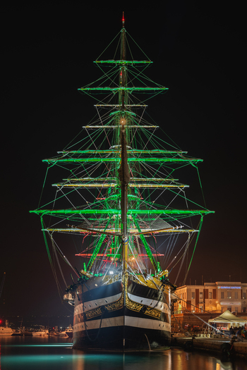 Ancona Italy 12 October 2022 View of the Amerigo Vespucci tall ship illuminated with green lights at night in the harbor.